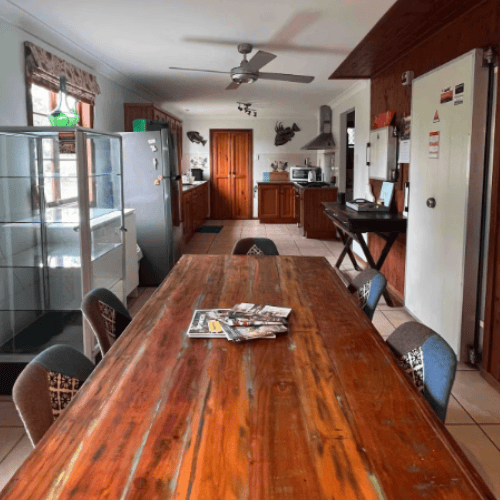 dining room with wooden table overlooking large kitchen at bnb