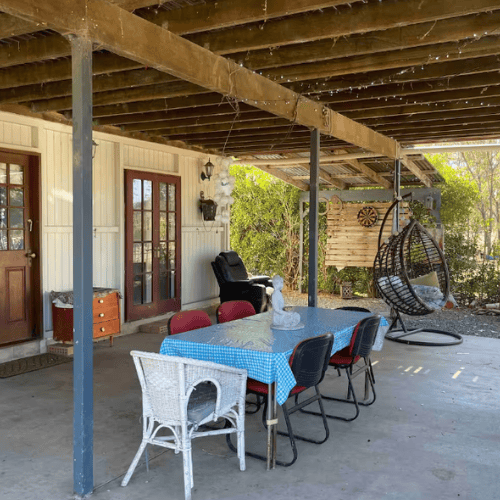 patio with egg chairs, table and chairs and fire pit at bnb in lockyer valley