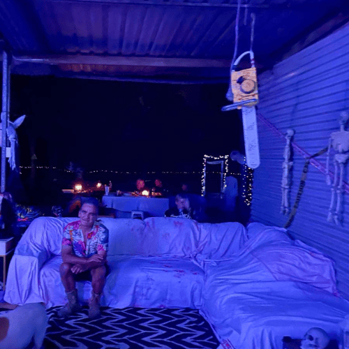person sitting on couch for guests at venue decorated for halloween 